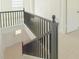 View of a renovated staircase with dark wood railing and light flooring at 2827 Sanctuary Ln, Winter Garden, FL 34787