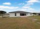 House back view showing a patio and grassy backyard at 2869 Blush Dr, Lakeland, FL 33813