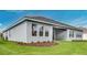 Expansive backyard showcasing the home's exterior with lush green grass and manicured landscaping at 2983 Arranmore Dr, Ormond Beach, FL 32174