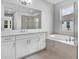 Bright bathroom with double vanity, separate soaking tub, and glass-enclosed shower at 2983 Arranmore Dr, Ormond Beach, FL 32174