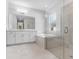 Bright bathroom with double vanity, glass enclosed shower, soaking tub, and lots of natural light at 2983 Arranmore Dr, Ormond Beach, FL 32174
