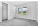 Spacious bedroom with neutral carpet, light grey walls, bright natural light, and a walk-in closet at 2983 Arranmore Dr, Ormond Beach, FL 32174