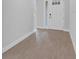 Clean entryway featuring wood floors with light gray walls and a bright white door at 2983 Arranmore Dr, Ormond Beach, FL 32174