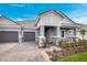 Stunning home showcasing a two-car garage, stone pillars, and a manicured lawn in a well-maintained community at 2983 Arranmore Dr, Ormond Beach, FL 32174