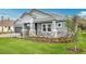 Charming single-Gathering home featuring a well-manicured lawn, stone accents, and a two-car garage at 2983 Arranmore Dr, Ormond Beach, FL 32174