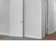 Hallway featuring three doors, neutral walls and trim, and neutral-colored flooring at 2983 Arranmore Dr, Ormond Beach, FL 32174