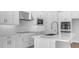 This immaculate kitchen boasts white cabinets, stainless steel appliances, and a center island at 2983 Arranmore Dr, Ormond Beach, FL 32174