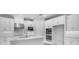 Bright kitchen featuring white cabinetry, stainless steel appliances, and a functional island with a modern faucet at 2983 Arranmore Dr, Ormond Beach, FL 32174