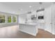 Spacious kitchen with white cabinets, stainless steel appliances, an island, and lots of natural light from the large windows at 2983 Arranmore Dr, Ormond Beach, FL 32174