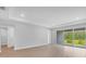 Bright, open living space with access to the backyard through sliding glass doors and sleek, modern flooring at 2983 Arranmore Dr, Ormond Beach, FL 32174