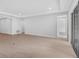 Spacious and bright living room with wood-look flooring, large windows, and access to an outdoor patio at 2983 Arranmore Dr, Ormond Beach, FL 32174