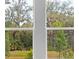 Window view featuring lush trees and an expansive lawn at 2983 Arranmore Dr, Ormond Beach, FL 32174