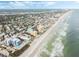 Stunning aerial view capturing the beachfront community, coastline, and ocean views at 421 S Atlantic Ave # 105, New Smyrna Beach, FL 32169