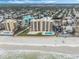 Aerial view of beachfront building, pool, and parking at 421 S Atlantic Ave # 105, New Smyrna Beach, FL 32169