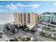 Aerial view of building, parking lot, and beach at 421 S Atlantic Ave # 105, New Smyrna Beach, FL 32169