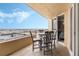 Balcony with seating area overlooking the pool and scenic ocean view at 421 S Atlantic Ave # 105, New Smyrna Beach, FL 32169