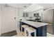Kitchen with stainless appliances, white cabinets, and breakfast bar with barstool seating at 421 S Atlantic Ave # 105, New Smyrna Beach, FL 32169