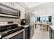 This kitchen features stainless appliances with view into living and dining area with ocean views at 421 S Atlantic Ave # 105, New Smyrna Beach, FL 32169