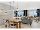 Bright living area with dining table and ocean views from the large sliding glass door at 421 S Atlantic Ave # 105, New Smyrna Beach, FL 32169