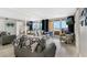 Stylish living room features sliding doors to balcony with ocean views, and large mirrors at 421 S Atlantic Ave # 105, New Smyrna Beach, FL 32169