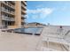 Community pool with lounge chairs and ocean views at 421 S Atlantic Ave # 105, New Smyrna Beach, FL 32169
