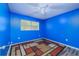 Bedroom with blue walls, wood-look floors, and ceiling fan at 507 Applewood Ave, Altamonte Springs, FL 32714