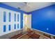 Blue bedroom with wood-look floors and double-door closet at 507 Applewood Ave, Altamonte Springs, FL 32714