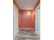 Laundry room with coral walls and neutral tile flooring at 507 Applewood Ave, Altamonte Springs, FL 32714