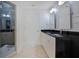 Modern bathroom with double vanity, granite countertop, and a walk-in shower at 630 Vassar St # 2310, Orlando, FL 32804