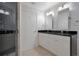 Modern bathroom with double vanity, granite countertop, and a walk-in shower at 630 Vassar St # 2310, Orlando, FL 32804