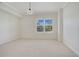 Cozy bedroom with neutral tones and a view of outside greenery at 630 Vassar St # 2310, Orlando, FL 32804
