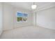 Spacious bedroom with plush carpet and large window with plantation shutters at 630 Vassar St # 2310, Orlando, FL 32804