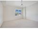 Spacious bedroom with plush carpet and large window with plantation shutters at 630 Vassar St # 2310, Orlando, FL 32804