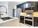 Modern kitchen with stainless steel appliances and a breakfast bar at 630 Vassar St # 2310, Orlando, FL 32804