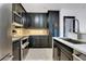 Modern kitchen boasts sleek black cabinets, stainless steel appliances, and bright countertops at 630 Vassar St # 2310, Orlando, FL 32804