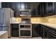 Kitchen with stainless steel appliances and dark cabinetry at 630 Vassar St # 2310, Orlando, FL 32804
