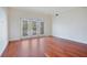 Bright living room with hardwood floors and access to a private balcony at 630 Vassar St # 2310, Orlando, FL 32804