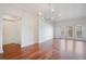 Open-concept living room featuring hardwood floors, a stylish chandelier, and abundant natural light at 630 Vassar St # 2310, Orlando, FL 32804