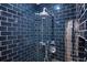 Modern shower with dark blue tile and chrome fixtures at 630 Vassar St # 2310, Orlando, FL 32804
