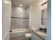 Clean bathroom featuring a bathtub, granite vanity, and marble tile at 6365 Sw 156 Th St St, Ocala, FL 34473