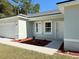 Front entrance of a newly built light green house with walkway at 6365 Sw 156 Th St St, Ocala, FL 34473