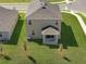 Aerial view of a two-story home featuring a well-manicured lawn at 7100 Cherry Pasture Rd, Groveland, FL 34736