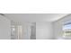 Clean, spacious bedroom with neutral walls, multiple doorways, and natural light at 7100 Cherry Pasture Rd, Groveland, FL 34736