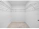 Walk-in closet featuring neutral walls, carpet, and wire shelving at 7100 Cherry Pasture Rd, Groveland, FL 34736