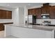 Bright kitchen with granite countertops, stainless steel appliances, and dark wood cabinetry at 7100 Cherry Pasture Rd, Groveland, FL 34736