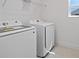 Convenient laundry room equipped with a modern washer and dryer set and overhead shelving at 7100 Cherry Pasture Rd, Groveland, FL 34736