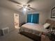 Bedroom with ceiling fan, carpet and view into the bathroom at 930 Brennam Pl, Longwood, FL 32750