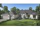 Single-story home with gray roof, two-car garage, and landscaped lawn at Lot 12 Yellowleaf Cir, Orlando, FL 32820