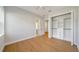 Bright bedroom featuring a ceiling fan, closet, and wood floors at 10750 Sw 110Th St, Dunnellon, FL 34432