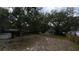 Spacious backyard with mature trees and shed at 13811 County Road 109D, Lady Lake, FL 32159